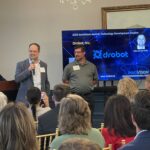 Stijn Van de Velde and Joseph Etris of Drobot address attendees at Meet the Finalists