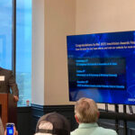 Hunter Freeman, InnoVision Awards board member and IP attorney at Kim, Lahey & Killough Law Firm, stands at the podium to close the Meet the Finalists and informs the crowd of upcoming InnoVision events