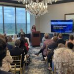 Kella Player Hanna of SCRA Founder stands at the podium as she opens the 2025 Meet the Finalists
