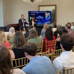 Matthew Cuppelli of Blue Ridge Surgical Innovations and OrthoTract addresses attendees at Meet the Finalists as his colleague Jackie Hanna looks on.