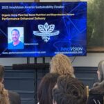 Attendees look toward a screen displaying a headshot of founder Richard Johnson, and the logo of his company Performance Enhanced Delivery - a Sustainability Finalist for the 2025 InnoVision Awards