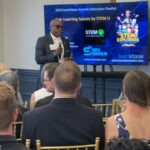 Christopher Williams of STEM U LLC addresses attendees at Meet the Finalists