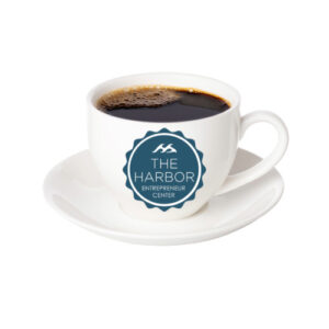 white coffee cup with a Harbor Entrepreneur Center logo
